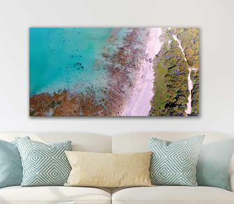 Aerial photograph of stunning Point Peron Beach reflecting a birds-eye view perspective of the serenity of this stretch of the West Australian coastline showing off the beautiful crystal clear turquoise waters lapping gently onto a white sandy beach - available in a selection of canvas sizes.